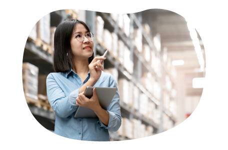Electronics wholesaler employee checking stock of computers in a warehouse. Electronics wholesaler employee checking stock of computers in a warehouse.