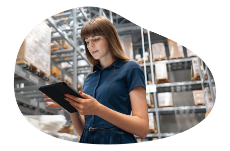 Cosmetics distributor employee checking orders in a warehouse.