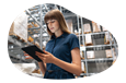 Cosmetics distributor employee checking orders in a warehouse.