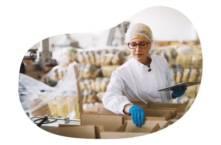 Food and beverage wholesaler employee packaging items for a shipment in a facility.