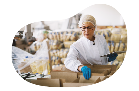 Food and beverage wholesaler employee packaging items for a shipment in a facility. Food and beverage wholesaler employee packaging items for a shipment in a facility.