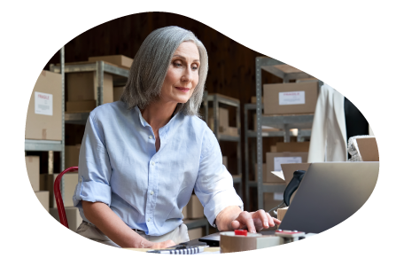 Jewelry wholesaler employee checking inventory on a laptop. Jewelry wholesaler employee checking inventory on a laptop.