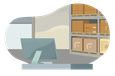Boxes of plumbing supplies on shelves next to a desk and computer.
