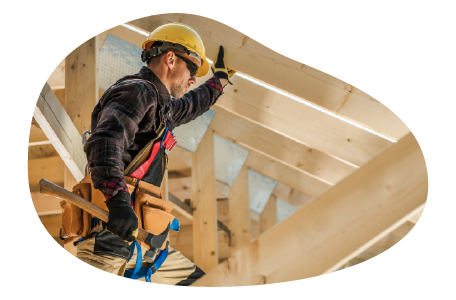 A construction worker building the roof of a new house