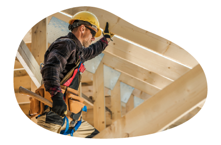 A construction worker building the roof of a new house