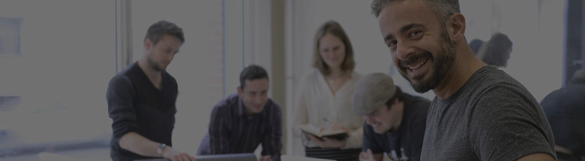 Small business owner working with team on a creative project.