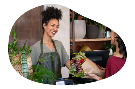 A small business owner giving a customer their order