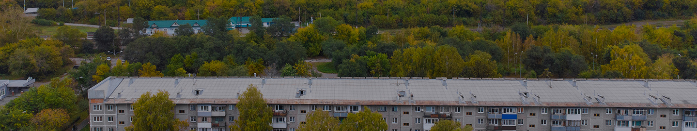 Manufacturing warehouse in a lush green environment.