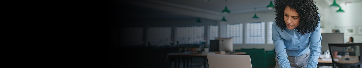 Business owners making notes from laptop.