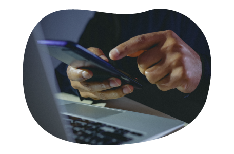 Small business owner doing calculations on phone.