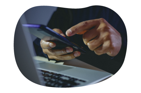 Small business owner doing calculations on phone.