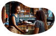 A cafe owner gives a customer their coffee order