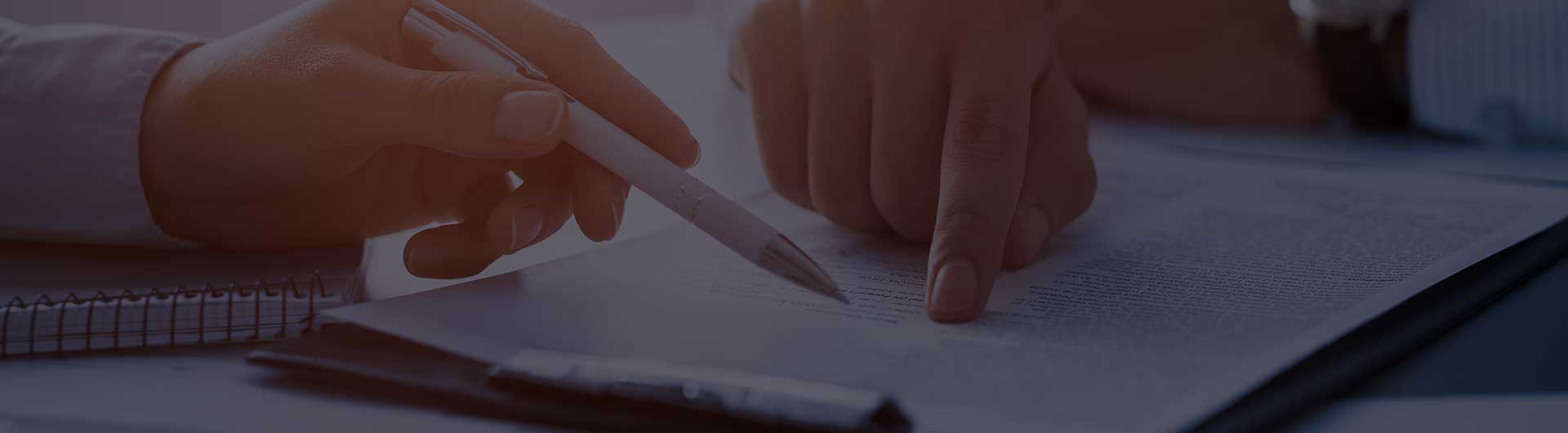 Two people working on a document together. Two people working on a document together.