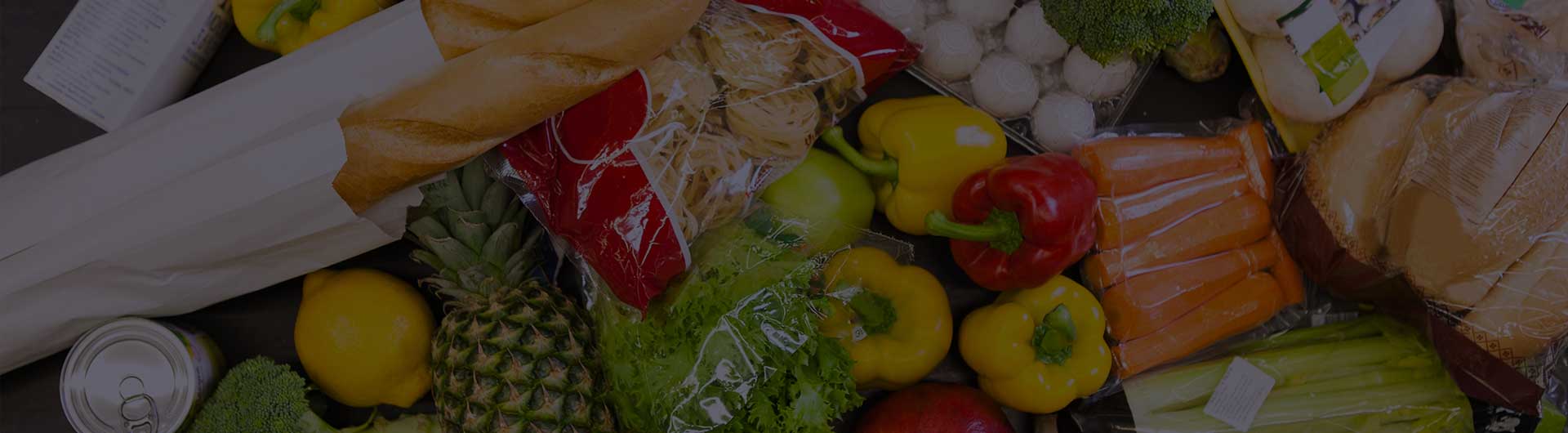 A lot of food on the counter in supermarket.