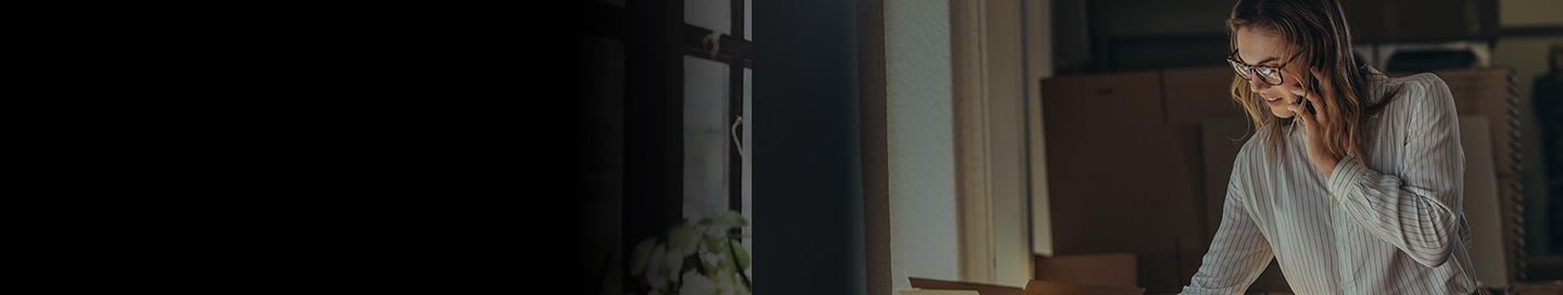 Business owner discussing order on phone. Business owner discussing order on phone.