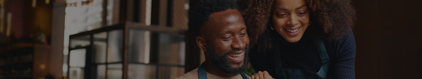 Two people reviewing franchise business sales.