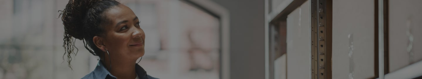 S Corporation business owner looking at files inside an office.