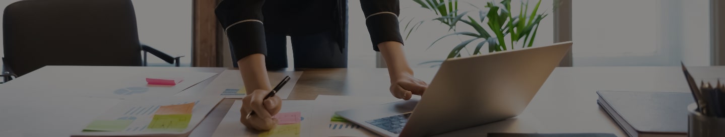 Sole proprietor reviewing work on their computer.