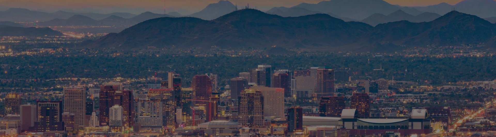 Sky view of downtown Phoenix and surrounding mountains.