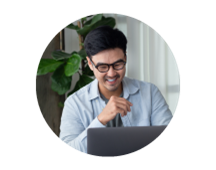 A small business owner chooses a policy on their laptop. A small business owner chooses a policy on their laptop.